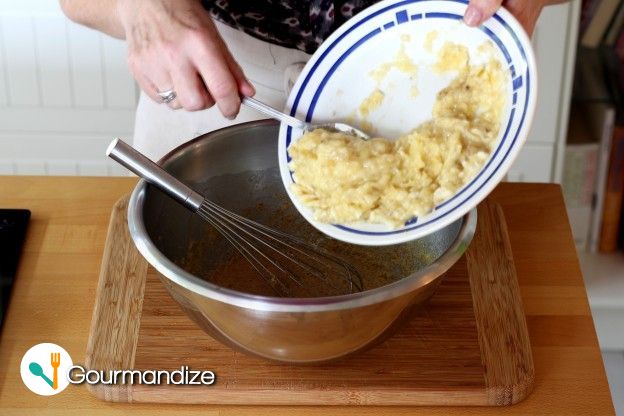 Add the mashed banana to the buttery sugar mixture and whisk