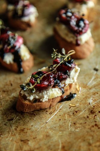 Crostini with roasted cherries and thyme on almond ricotta with honey and balsamic