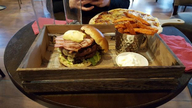 A bacon burger in a crate