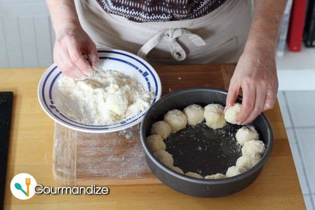 Next place the balls into a round oiled baking mold in one layer