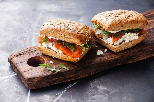 Smoked salmon, arugula and feta sandwich on a multi-grain bun