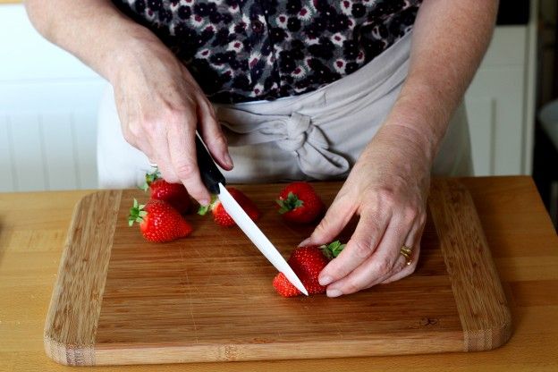 Cut off the bottom tip of the strawberries