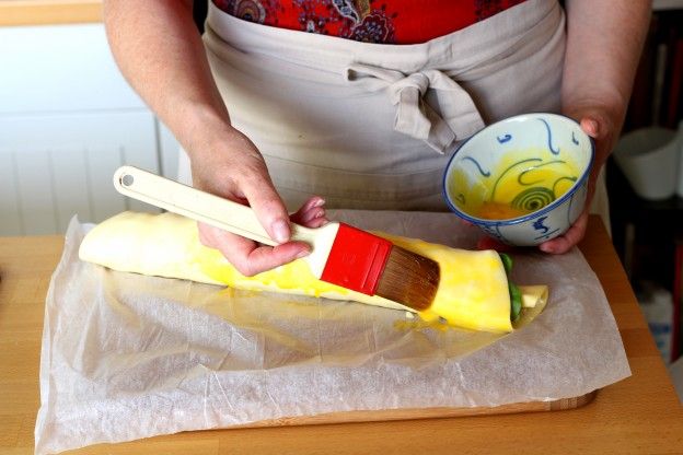 Brush the rolled puff pastry with the mixture of egg yolk and milk