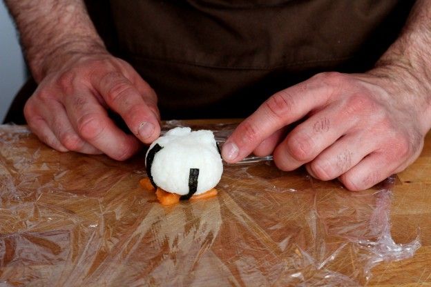 Place the rice ball onto the salmon