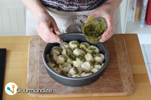 Add half of the pesto on top of the first layer and a bit of Parmesan