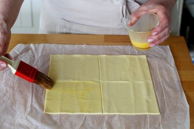 Brush the puff pastry with the mixture of egg yolk and milk