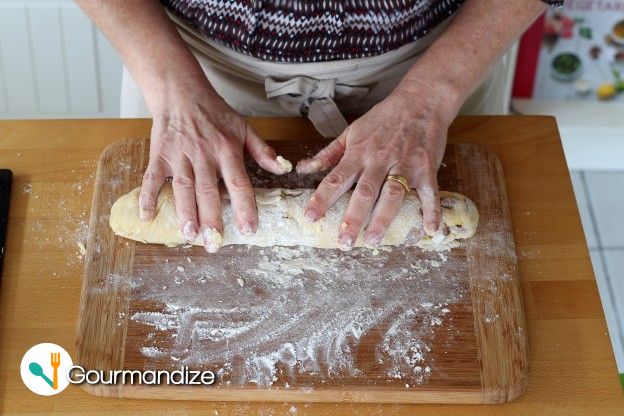 Shape the ball into a long roll on a floured surface