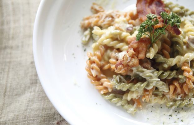 Tricolor pasta in Parmesan cream sauce with bacon