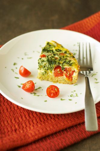 Quinoa breakfast casserole with tomato and spinach