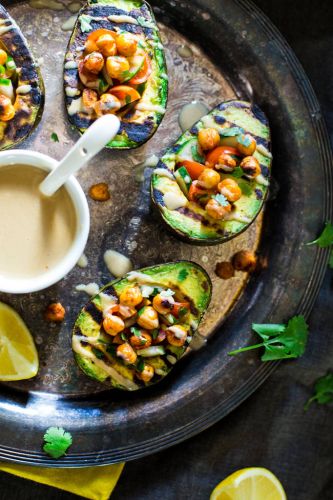 Mediterranean grilled avocado stuffed with chickpeas and tahini