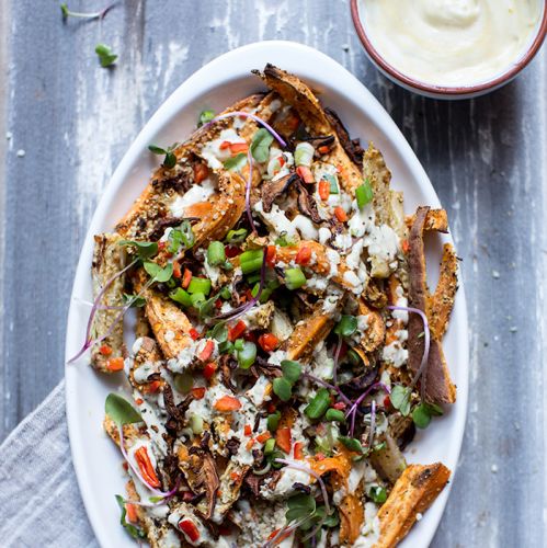 Loaded sweet potato and root vegetable fries with shiitake 'bacon' and garlic tahini