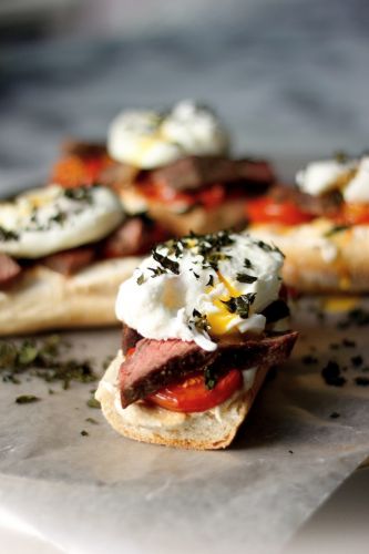 STEAK AND EGG BREAKFAST BRUSCHETTA WITH CRISPY KALE, GOAT CHEESE, AND ROASTED TOMATOES